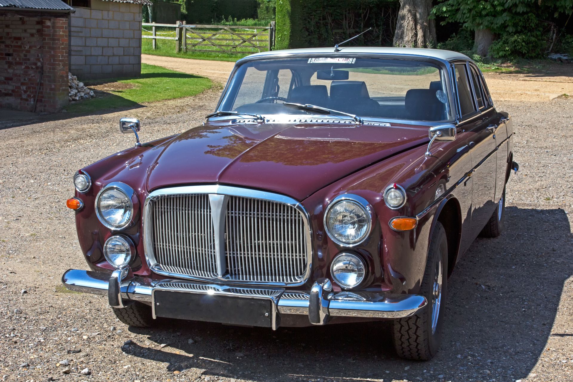 A British classic car parked on the road in the countryside